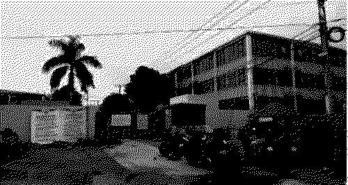 industrial building with motorbikes parked out front